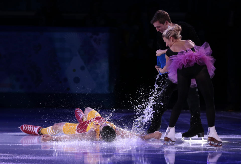 Javier Fernandez of Spain, left, has water poured over him by Kirsten Moore-Towers and Dylan Moscovitch of Canada as they perform during the figure skating exhibition gala at the Iceberg Skating Palace during the 2014 Winter Olympics, Saturday, Feb. 22, 2014, in Sochi, Russia. (AP Photo/Ivan Sekretarev)