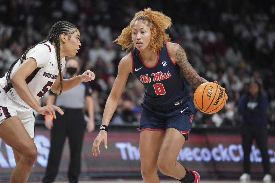 Mississippi forward Shakira Austin (0) dribbles against South Carolina forward Victaria Saxton (5) during the first half of an NCAA college basketball game Thursday, Jan. 27, 2022, in Columbia, S.C. (AP Photo/Sean Rayford)