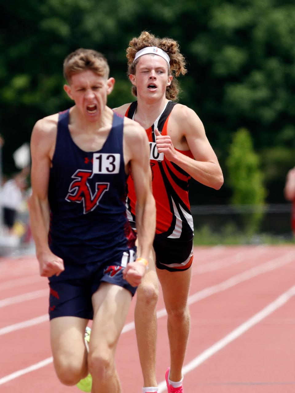 Waverly's Mitch Green is edged at the finish line by Gnadenhutten Indian Valley's Xander Heil en route to a second-place finish in the 1,600 meters during the Division II regional track and field meet on Saturday at McConagha Stadium in New Concord.