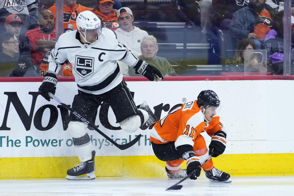 Los Angeles Kings' Anze Kopitar, left, and Philadelphia Flyers' Travis Konecny collide during the third period of an NHL hockey game, Tuesday, Jan. 24, 2023, in Philadelphia. (AP Photo/Matt Slocum)