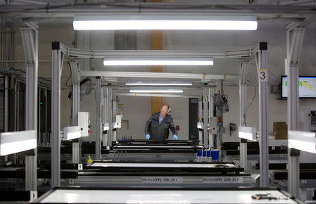 FILE PHOTO: A production operator checks a panel at the SolarWorld solar panel factory in Hillsboro, Oregon, U.S, January 15, 2018. REUTERS/Natalie Behring/File Photo