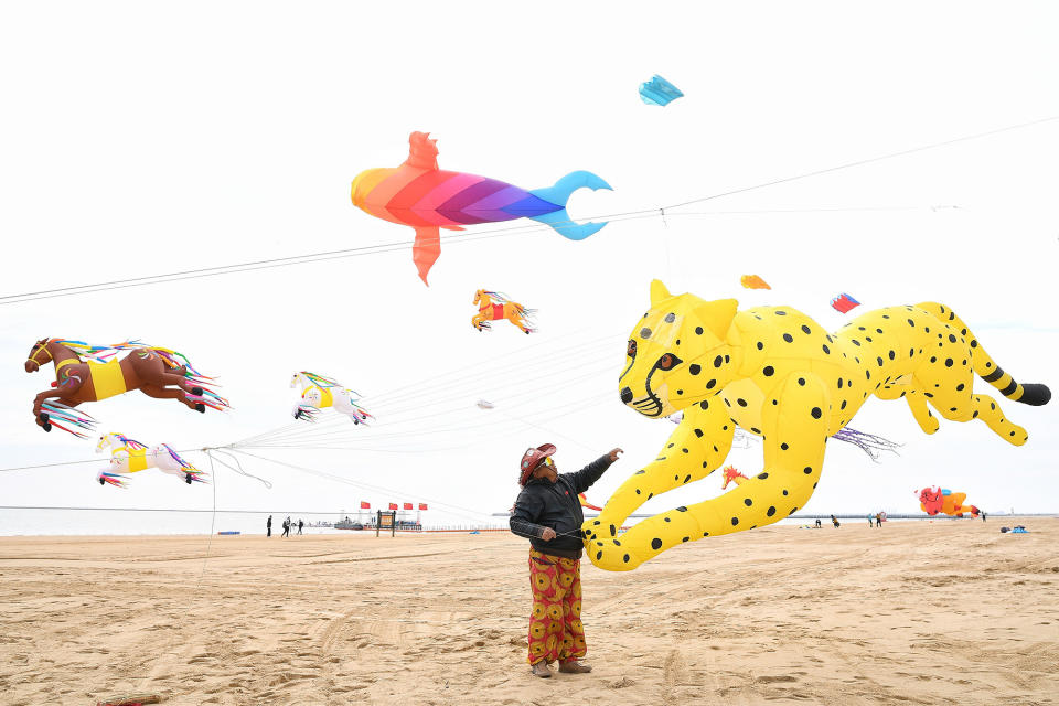 People fly kites at Dongjiang Bay Beach in Tianjin, China, on April 5, 2023.