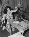 <p>The <em>Whatever Happened to Baby Jane</em> Academy Award-winner prepares to show home movies in the living room of her Brentwood estate. </p>