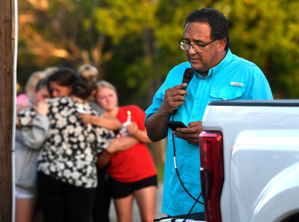 At the intersection where three teens were killed, David Avecedo, the pastor of First Baptist Church in Baird, delivers a prayer during a memorial service May 7.