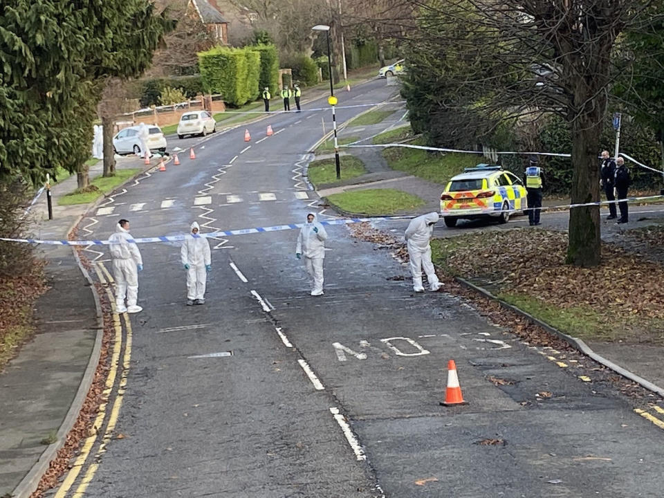 Forensic and police officers examine the scene of the fatal stabbing in Rushden. Northampton (Picture: PA)