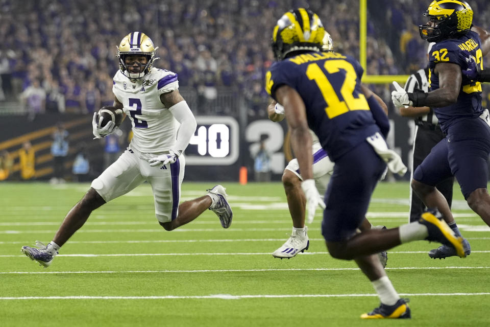 Washington wide receiver Ja'Lynn Polk runs against Michigan during the first half of the national championship NCAA College Football Playoff game Monday, Jan. 8, 2024, in Houston. (AP Photo/Eric Gay)