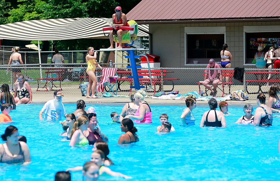 Brookside Pool manager Missy Dropsey watches from the lifeguard chair as she helps out with manning one of the chairs on Wednesday, June 15, 2022. TOM E. PUSKAR/ASHLAND TIMES-GAZETTE