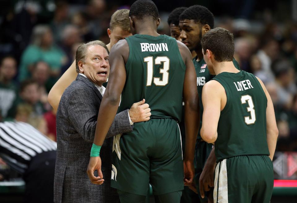 Michigan State Spartans head coach Tom Izzo talks to Michigan State Spartans forward Gabe Brown (13) and Michigan State Spartans guard Foster Loyer (3) and Michigan State Spartans forward Aaron Henry (11) during the second half of a game against the Oakland Golden Grizzlies at the Breslin Center.