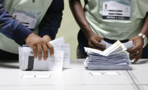 Maldivian polling workers prepare to count ballots at the end of the presidential election day in Male, Maldives, Sunday, Sept. 23, 2018. As officials began tabulating votes after the polls closed at 7 p.m., people in the Maldives and observers outside the tiny, tropical South Asian country waited for the results to see whether the opposition's cries of a rigged vote would be validated. (AP Photo/Eranga Jayawardena)