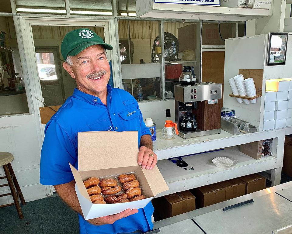 Shelbyville Optimist member Brent Pewitt holds a dozen of the doughnuts sold at club's booth at the Tennessee Walking Horse National Celebration, which takes place the 10 days before Labor Day weekend annually. Since 1960, the club has served untold millions to fans across the world.