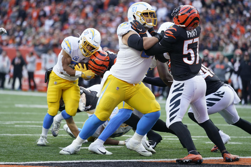 Los Angeles Chargers' Austin Ekeler (30) runs in for a touchdown during the second half of an NFL football game against the Cincinnati Bengals, Sunday, Dec. 5, 2021, in Cincinnati. (AP Photo/Michael Conroy)