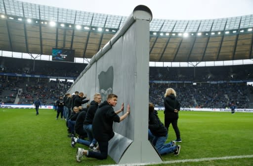 A symbolic wall, bearing the inscrition 'Against Walls together with Berlin', was set up across the pitch before the start of Hertha Berlin's match agaomst Leipzig at the Olymic Stadium in Berlin on Saturday