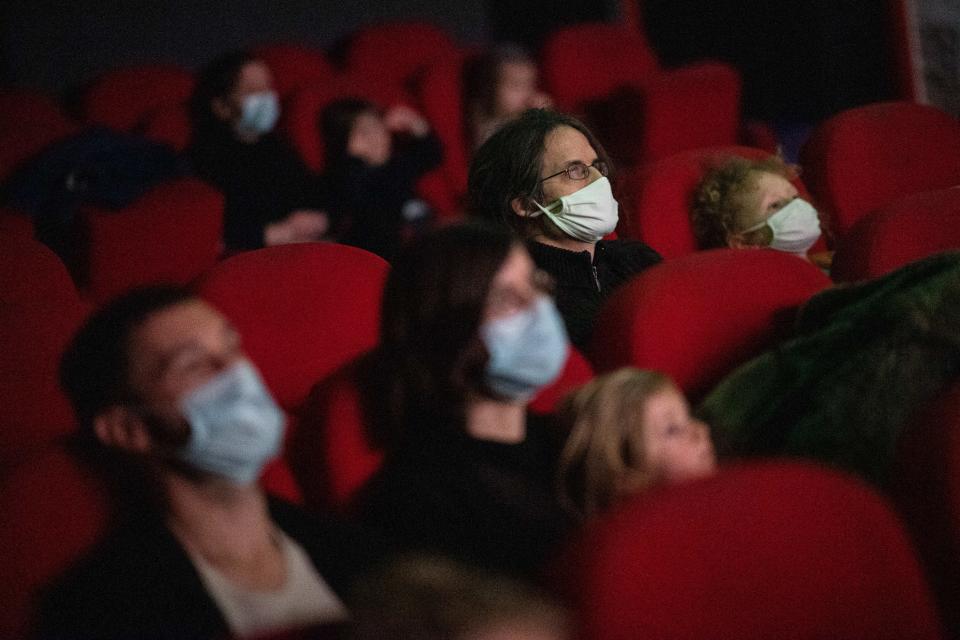 People watch a movie in a cinema theatre, on March 14, 2021 in Nantes, as part of a nationwide action to reopen movie theatres closed since the beginning of the covid-19 pandemic. 