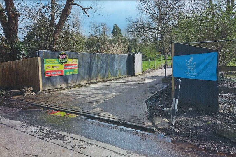 General view of gateway from road with sign for a farm shop