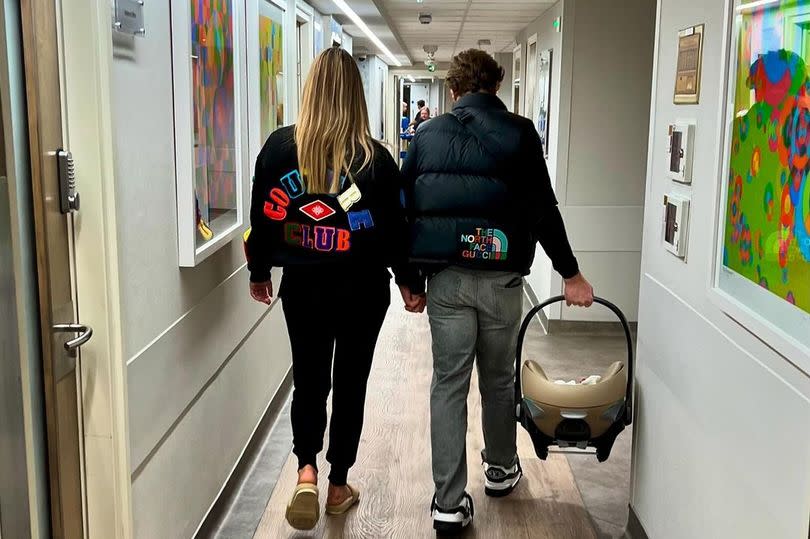 Olly Murs carries his new baby out the hospital