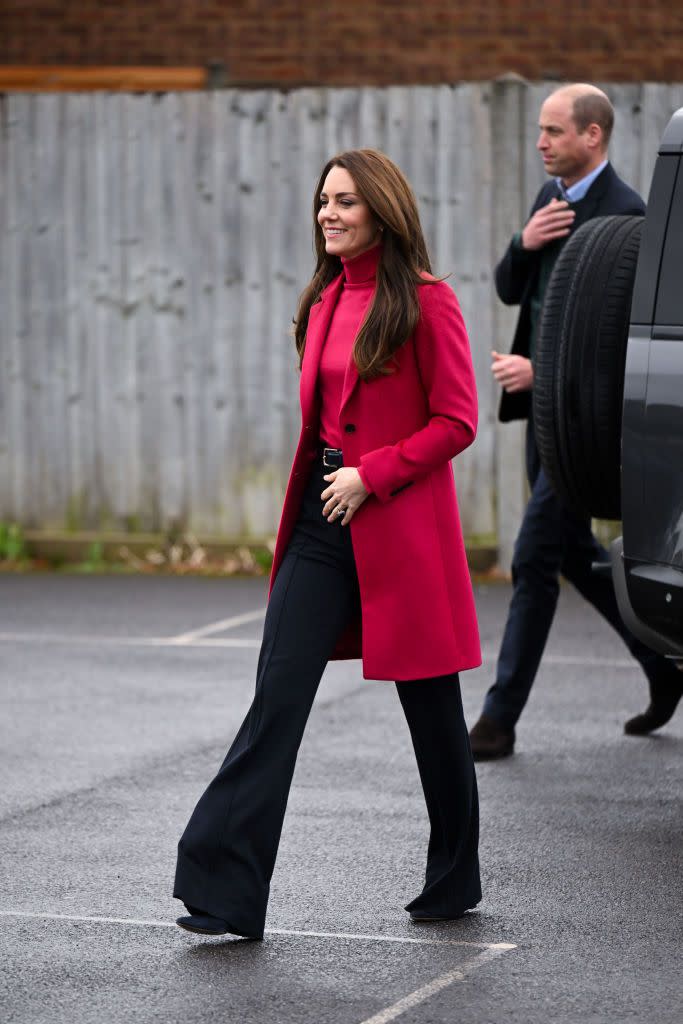<p>Kate looked glam in a hot pink Hobbs London coat and matching Hobbs turtleneck, that she paired with wide-legged navy pants.</p>