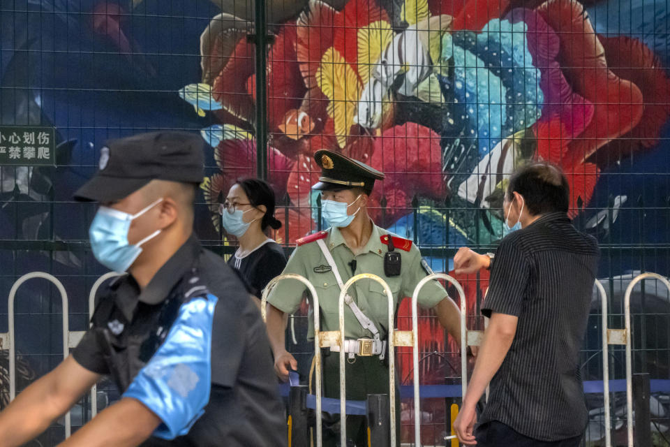A paramilitary policeman stands guard outside the U.S. Embassy in Beijing, Wednesday, Aug. 3, 2022. U.S. House Speaker Nancy Pelosi arrived in Taiwan late Tuesday, becoming the highest-ranking American official in 25 years to visit the self-ruled island claimed by China, which quickly announced that it would conduct military maneuvers in retaliation for her presence. (AP Photo/Mark Schiefelbein)