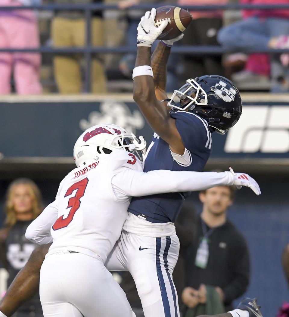Utah State wide receiver Jalen Royals catches a touchdown pass as Fresno State defensive back Al’zillion Hamilton (3) defends during the first half of an NCAA college football game Friday, Oct. 13, 2023, in Logan, Utah. | Eli Lucero/The Herald Journal via AP