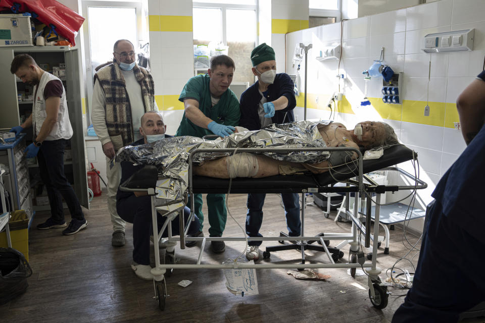 Doctors treat an injured local woman after shelling by Russian forces of residential neighbourhood at the hospital of Kostiantynivka, Ukraine, Friday, March 10, 2023. (AP Photo/Evgeniy Maloletka)