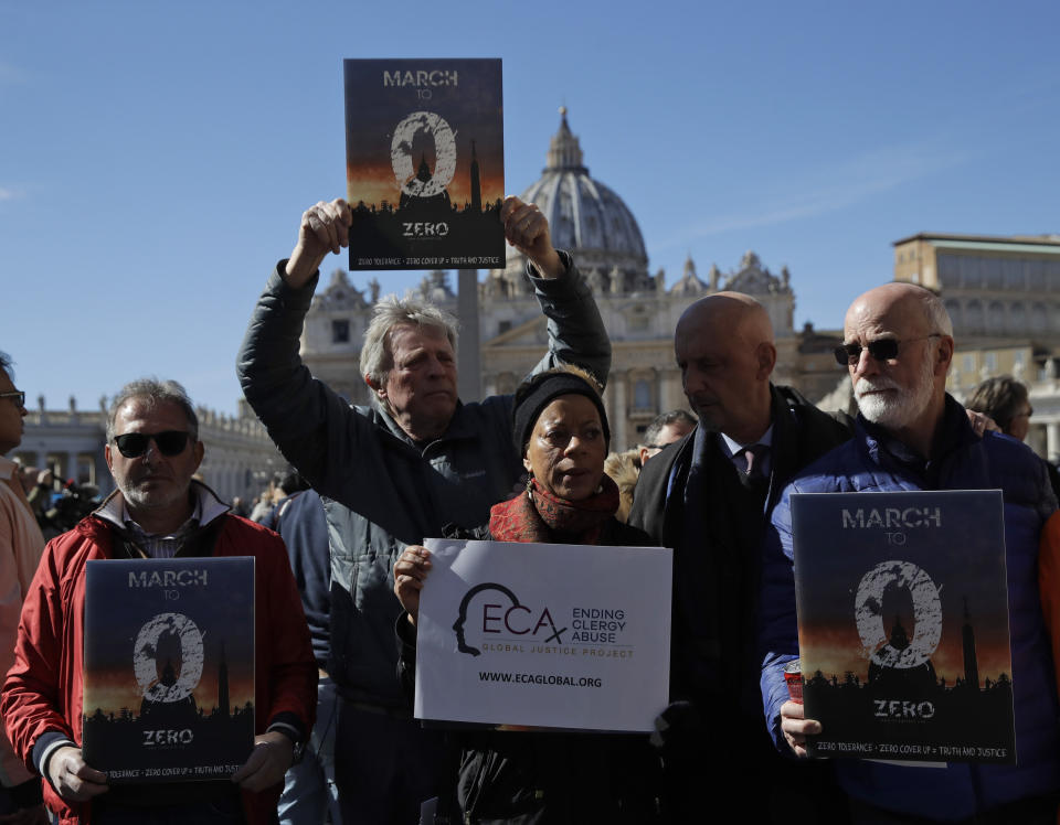 Sex abuse survivors and members of ECA (Ending Clergy Abuse), show banners in front of St. Peter's Square at the Vatican as they meet reporters, Sunday, Feb. 24, 2019. (AP Photo/Alessandra Tarantino)
