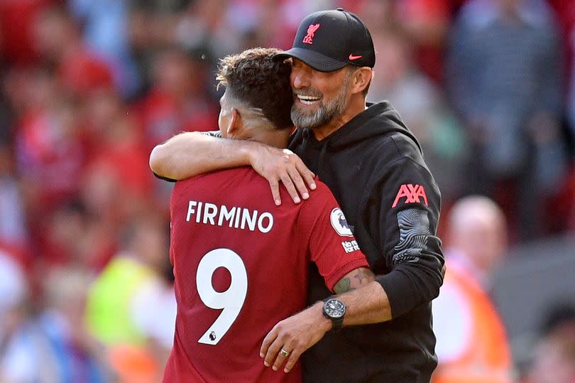 Roberto Firmino embraces Jürgen Klopp after being substituted in Liverpool vs Bournemouth in 2022.