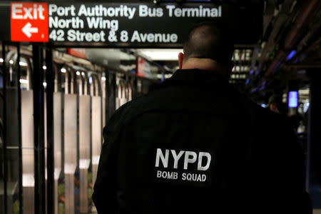A member of the New York Police Department's Bomb Squad walks through the 42nd Street subway station beneath the New York Port Authority Bus Terminal following an attempted detonation during the morning rush hour, in New York City, New York, U.S., December 11, 2017. REUTERS/Andrew Kelly