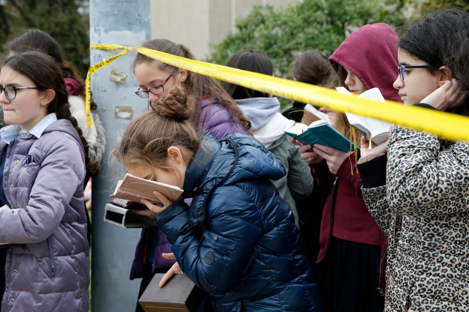 The mass shooting in October at a synagogue in Pittsburgh has been one of the most difficult assignments I have covered in my 23 years of experience. When I saw the young girls praying and singing outside of the synagogue just a few days after shooting, I saw a range of emotions. There was sadness but also strength and hope.
 
A student from Yeshiva Girls High School kisses her prayer book outside of the Tree of Life Congregation Synagogue in the Squirrel Hill neighborhood of Pittsburgh Monday, Oct. 27, 2018. Two days before, a gunman screamed anti-Semitic epithets as he opened fire on the congregants inside the Tree of Life Congregation. Eleven worshippers were killed, and six others wounded.