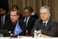 Ecuador's Foreign Minister Ricardo Patino (L) speaks next to Brazil's Foreign Minister Luiz Alberto Figueiredo during a meeting with representatives of the Venezuelan opposition, the Roman Catholic Church and Union of South American Nations (UNASUR) at Miraflores Palace in Caracas April 10, 2014. REUTERS/Carlos Garcia Rawlins