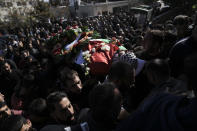 CORRECTS DETAILS OF DEATH Relatives carry the body of 17-year-old American Tawfiq Ajaq at his funeral in his family’s Palestinian home village in Al-Mazra'a ash-Sharqiya, West Bank, Saturday, Jan. 20, 2024. Ajaq was killed Friday by Israeli fire and police say they have launched an investigation. (AP Photo/Nasser Nasser)