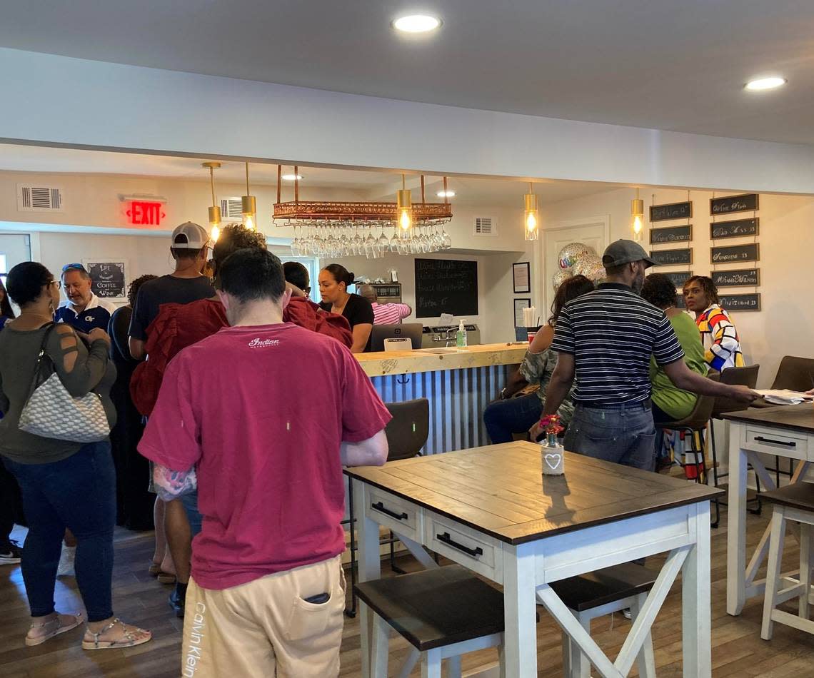 Customers line up at the bar at a recent soft opening event at La’Vino Wine Bar in Warner Robins.