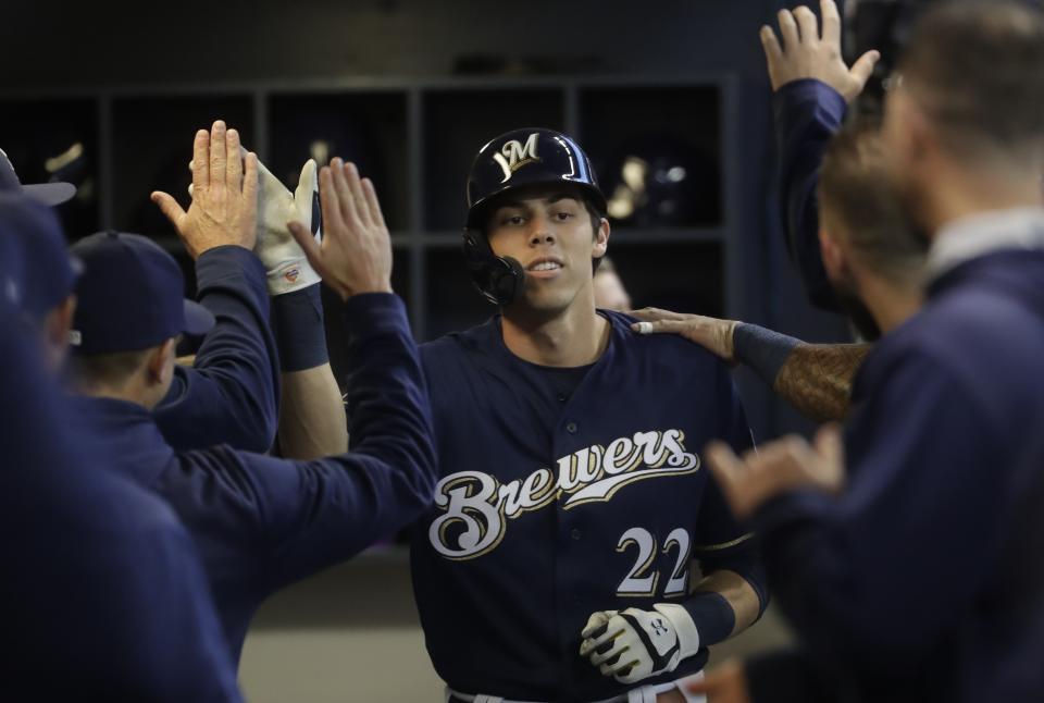 Milwaukee Brewers' Christian Yelich is congratulated after hitting a home run during the first inning of a baseball game against the St. Louis Cardinals Saturday, March 30, 2019, in Milwaukee. (AP Photo/Morry Gash)