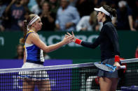 Tennis - WTA Tour Finals - Singapore Indoor Stadium, Singapore - October 22, 2017 Spain's Garbine Muguruza shakes the hand of Latvia's Jelena Ostapenko (L) after their group stage match REUTERS/Edgar Su