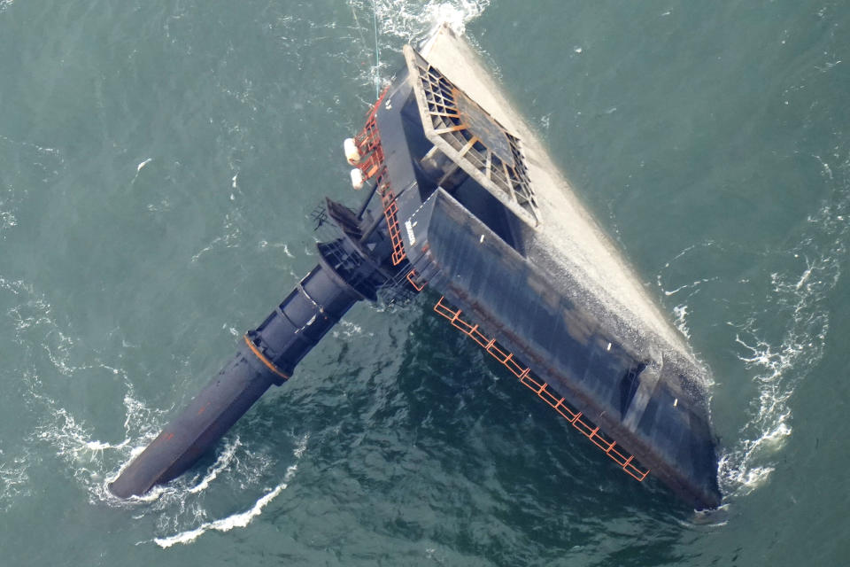 FILE - In this April 18, 2021, file photo, the capsized lift boat Seacor Power is about 7 miles off the coast of Louisiana in the Gulf of Mexico1. The vessel capsized during a storm. A man who was on the liftboat recalled Monday, Aug 2, 2021, how he hammered on a window with a fire extinguisher, was sucked into the sea by a wave and then prayed to God to calm the seas as he floated in the choppy waters before being rescued. Thirteen people were killed. (AP Photo/Gerald Herbert, File)