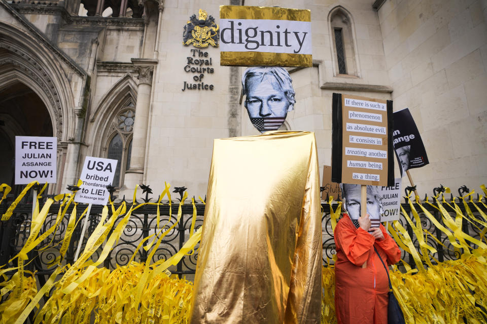 Demonstrators hold banners outside the Royal Courts of Justice in London, Tuesday, Feb. 20, 2024. Julian Assange’s lawyers will begin their final U.K. legal challenge to stop the WikiLeaks founder from being sent to the United States to face spying charges. The 52-year-old has been fighting extradition for more than a decade, including seven years in self-exile in the Ecuadorian Embassy in London and the last five years in a high-security prison. (AP Photo/Kirsty Wigglesworth)