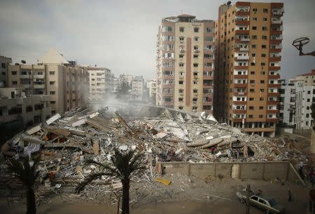A general view of the rubble of a residential tower, which witnesses said was destroyed in an Israeli air strike, is seen in Gaza City August 24, 2014. REUTERS/Mohammed Salem