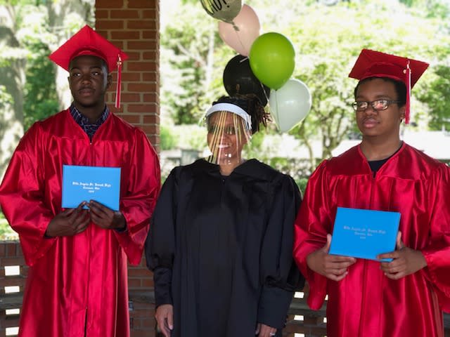 Judge Wanda C. Jones stands proudly with high school seniors Jalen McMillian (L) and Markel Washington (R) after officiating their graduation. (Photo: LaKishia McMillian)