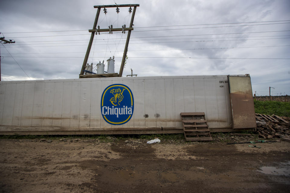 A Chiquita container sits on the side of the road where it was dragged by floodwaters during last year's hurricanes Eta and Iota at a banana packing plant in La Lima, on the outskirts of San Pedro Sula, Honduras, Wednesday, Jan. 13, 2021. The Sula Valley, Honduras’ most agriculturally productive, was so heavily damaged that international organizations have warned of a food crisis. (AP Photo/Moises Castillo)
