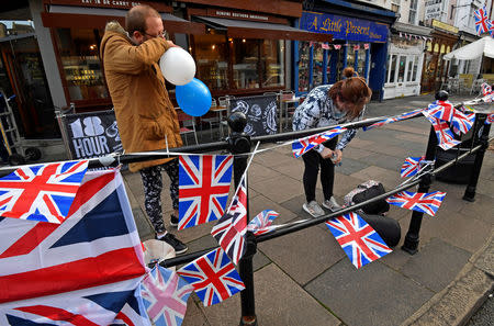 People blow up balloons and string up bunting, on the day before the royal wedding of Britain's Princess Eugenie and Jack Brooksbank, in Windsor, Britain, October 11, 2018. REUTERS/Hannah McKay