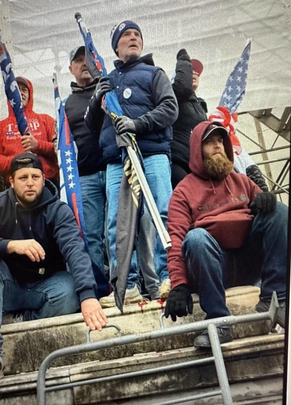 The government said Eric Harrower, right, and Joshua Dressel, sitting left, manned an overturned bike rack and appeared to watch as the mob attacked police during the Capitol riot.