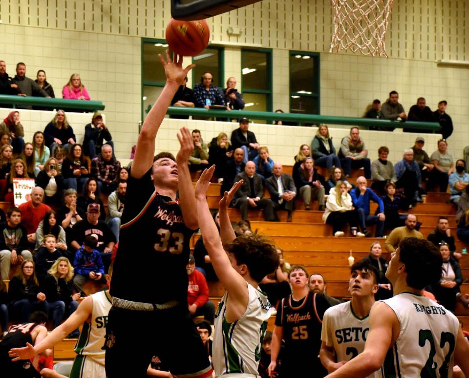 Oppenheim-Ephratah-St. Johnsville senior Owen Feagles (33) shoots over Plattsburgh-Seton Catholic's Ashton Guay during a Sunday's NYSPHSAA Class D regional game at Clinton Community College.