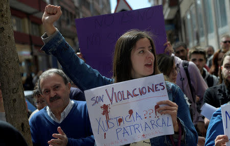 People shout slogans during a protest outside the courts of Aviles, after a Spanish court sentenced five men accused of the group rape of an 18-year-old woman at the 2016 San Fermin bull-running festival each to nine years in prison for the lesser charge of sexual abuse, in Spain, April 27, 2018. The sign reads: "they are violations, patriarchal justice". REUTERS/Eloy Alonso