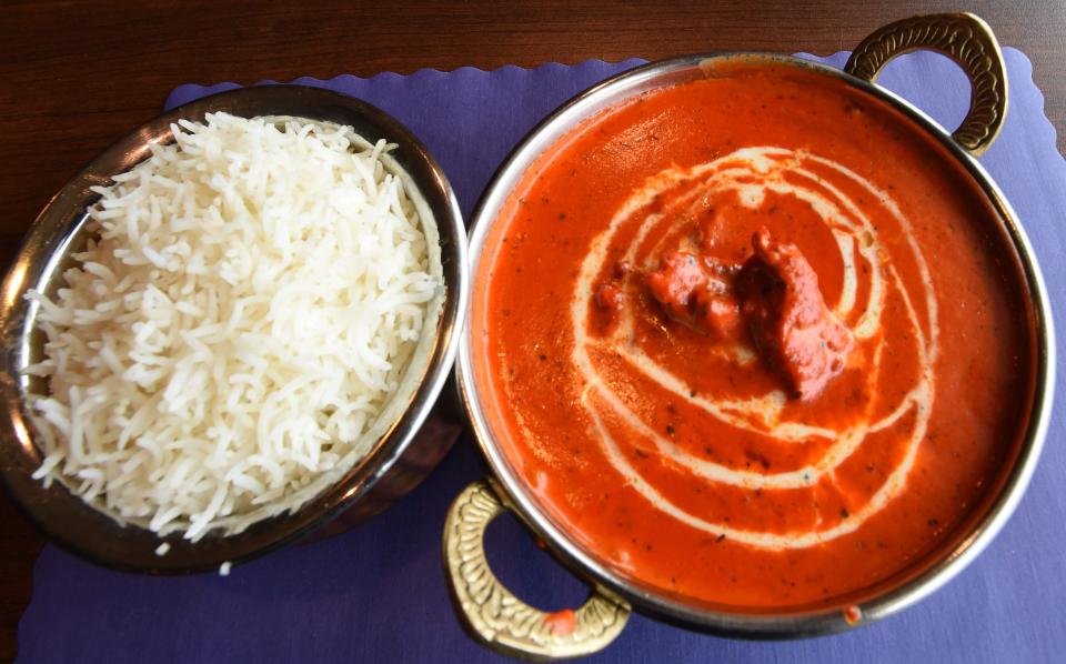 A serving of butter chicken and rice is served at Fine Restaurant and Bar located in the former Nunzi's at 2330 E. 38th St.