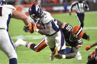 Denver Broncos running back Javonte Williams (33) dives into the end zone for a touchdown after a pass reception, as Cleveland Browns defensive end Takkarist McKinley (55) defends during the second half of an NFL football game Thursday, Oct. 21, 2021, in Cleveland. (AP Photo/David Richard)