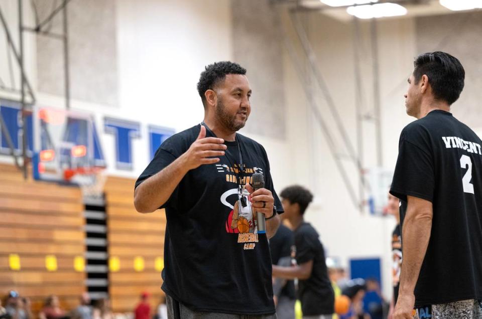 Bobby Cole Jr., left, works with one of the coaches during the Modesto Slam-N-Jam Youth Basketball Camp at Modesto Junior College in Modesto, Calif., Friday, July 7, 2023.