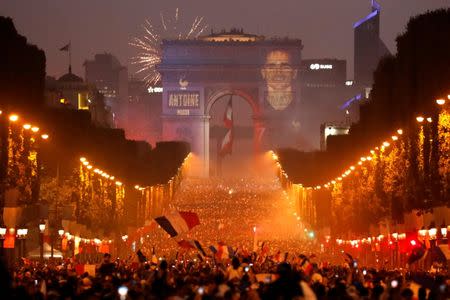 Soccer Football - World Cup - Final - France vs Croatia - Paris, France, July 15, 2018 - A giant picture of France's Antoine Griezmann is seen on the Arc de Triomphe as France fans celebrate on the Champs-Elysees Avenue after France won the Soccer World Cup final. REUTERS/Charles Platiau