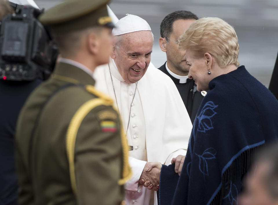 Lithuania's President Dalia Grybauskaite, right, welcomes Pope Francis after he landed at the airport in Vilnius, Lithuania, Saturday Sept. 22, 2018. Pope Francis begins a four-day visit to the Baltics amid renewed alarm about Moscow's intentions in the region it has twice occupied. (AP Photo/Mindaugas Kulbis)