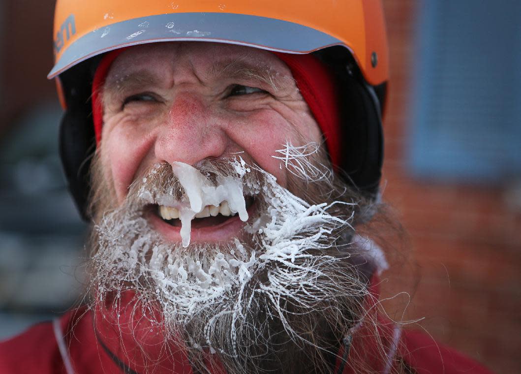 In a Feb.19, 2014 photo, Fraser Cunningham, 56, a General Electric engineer, arrives home in Madeira, Ohio, with ice that has formed on his beard, which is a product of freezing water vapors produced from breathing. Cunningham calls it his &quot;chinsulation.&quot; Cunningham hasn&#39;t missed a day biking to and from work for a year and a half. (AP Photo/The Cincinnati Enquirer, Carrie Cochran) MANDATORY CREDIT; NO SALES