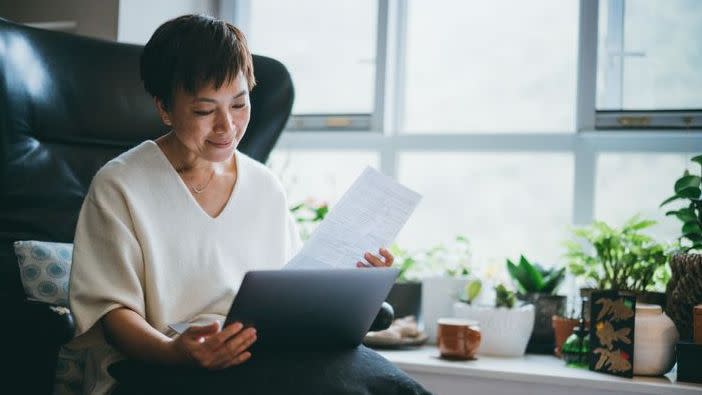 A woman looks over her 401(k) plan documents.