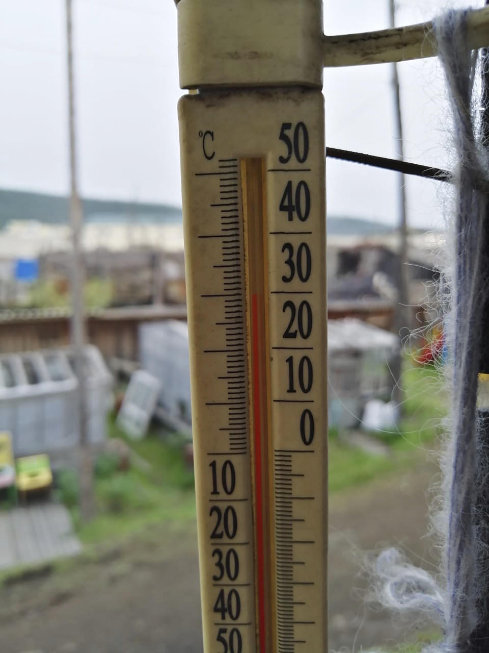 In this handout photo provided by Olga Burtseva, an outside thermometer shows 30 Celsius (86 F) around 11 p.m in Verkhoyansk, the Sakha Republic, about 4660 kilometers (2900 miles) northeast of Moscow, Russia, Sunday, June 21, 2020. A Siberian town that endures the world's widest temperature range has recorded a new high amid a hear wave that is contributing to severe forest fires. Russia's meteorological service said the thermometer hit 38 Celsius (100.4 F) on Saturday in Verkhoyansk, in the Sakha Republic about 4660 kilometers (2900 miles) northeast of Moscow. (Olga Burtseva via AP)