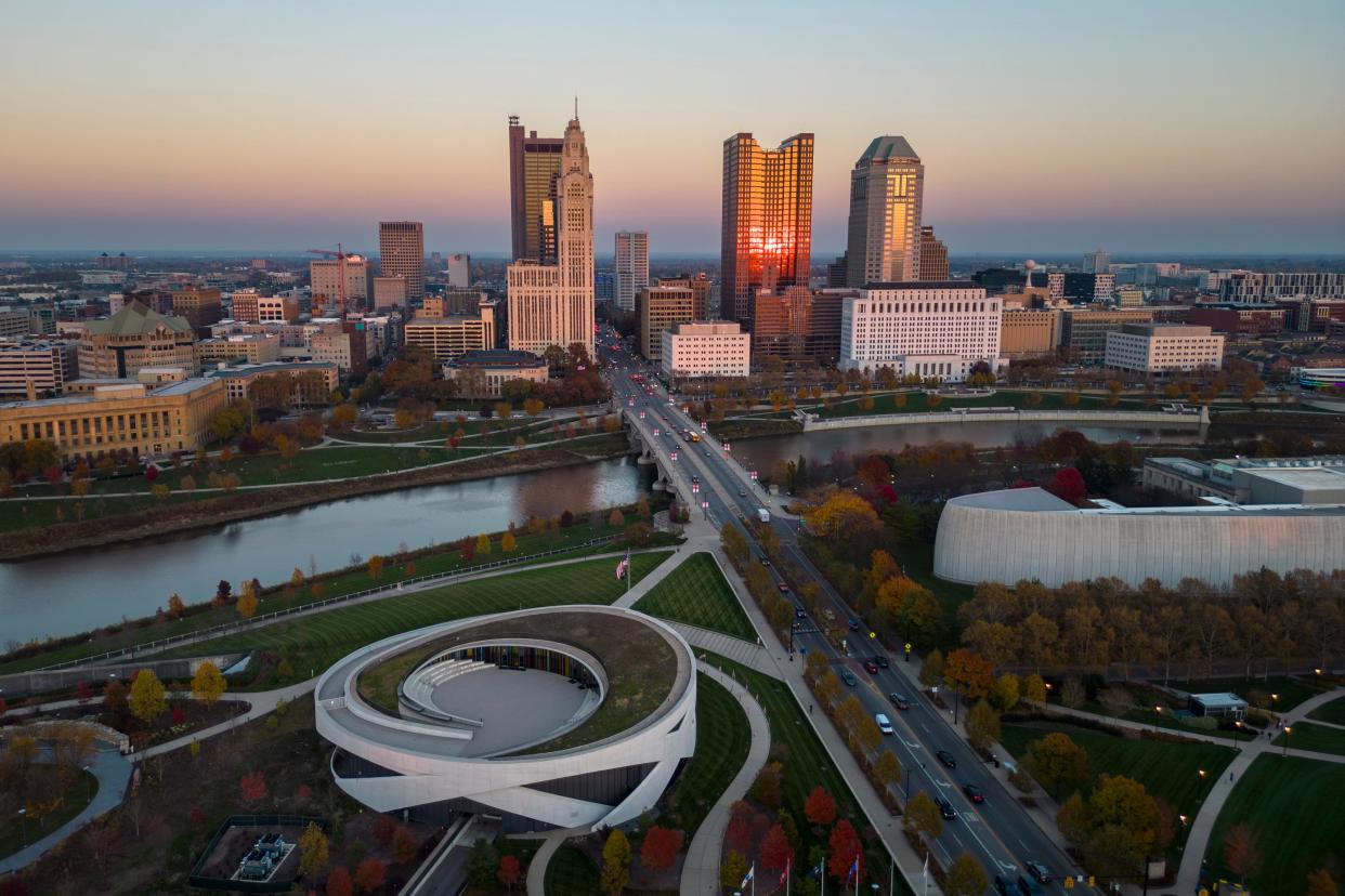 The setting sun illuminates the downtown Columbus skyline. After several days of warmer weather, cold may return for the remainder of winter in Columbus.